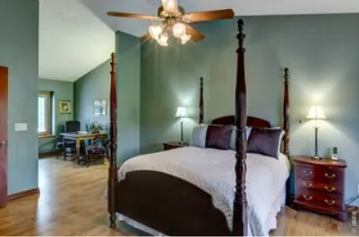 a bedroom with a large bed and a tv