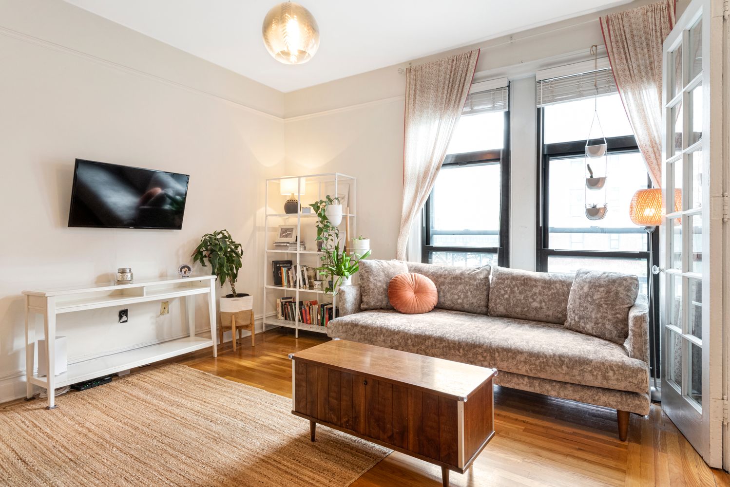 31 Tiemann Place, Unit 37 Manhattan, NY 10027 - Photo 8 of 10 a living room with furniture and a flat screen tv
