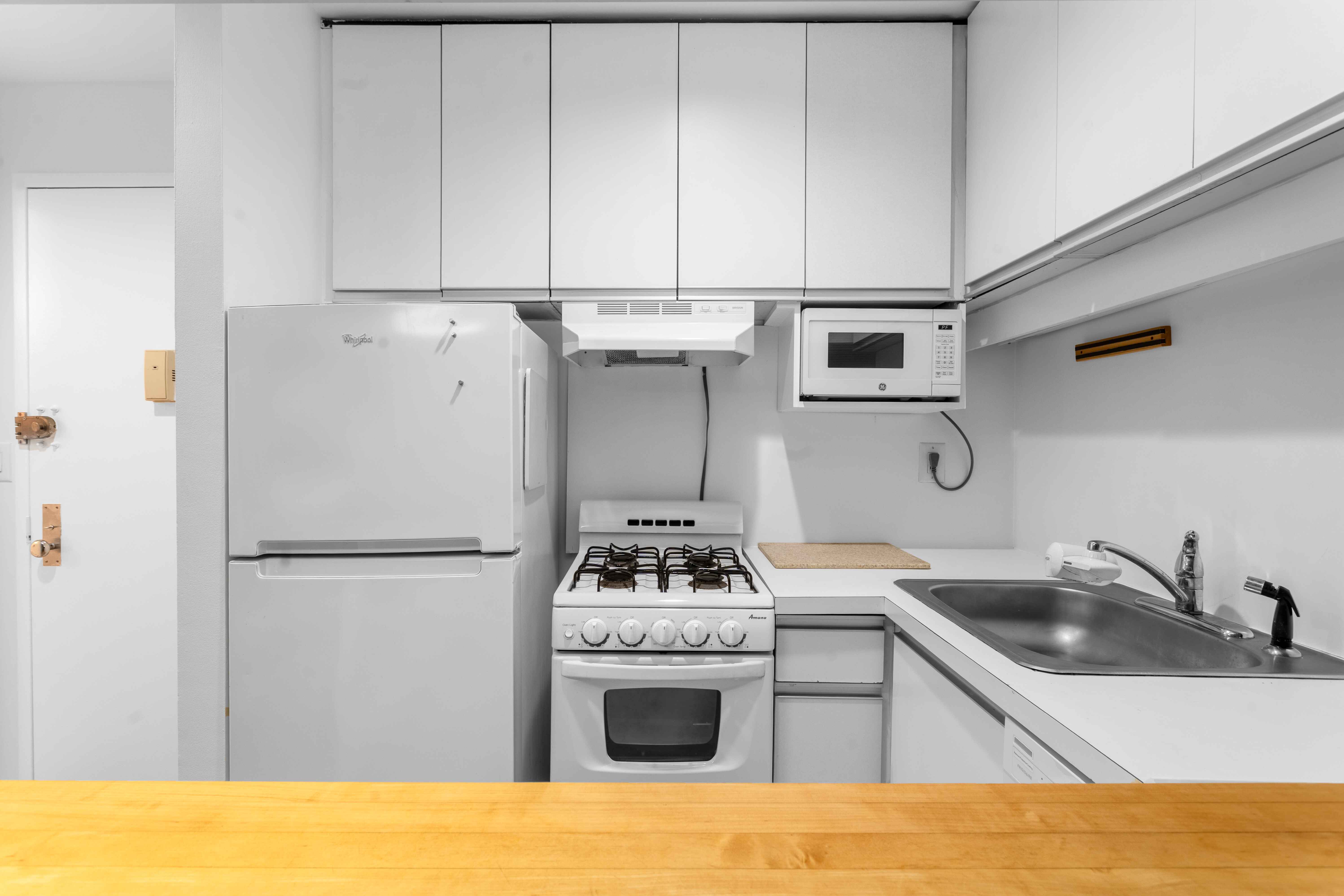 250 West 88th Street, Unit 408 Manhattan, NY 10024 - Photo 5 of 10 a kitchen with stainless steel appliances a refrigerator sink and stove