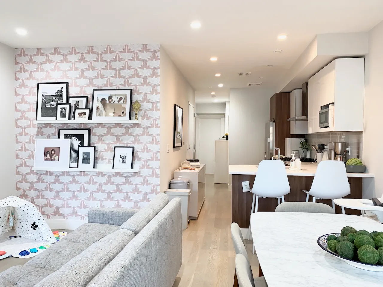 a living room with furniture and kitchen view