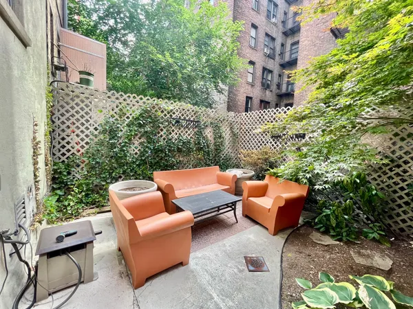 a backyard of a house with outdoor seating