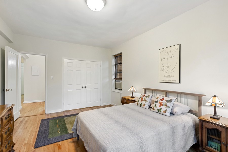 159-00 Riverside Drive West, Unit 5D Manhattan, NY 10032 - Photo 7 of 19 a bedroom with a bed and a painting on the wall