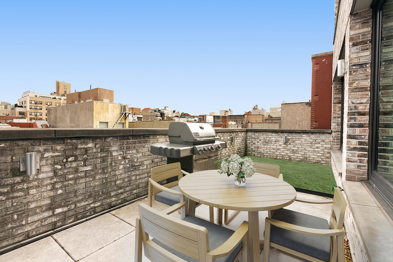 211 East 13th Street, Unit PH1B Manhattan, NY 10003 - Photo 5 of 8 a view of a terrace with furniture and a table