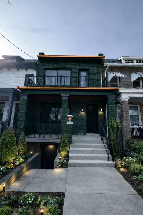 a front view of a house with a garden