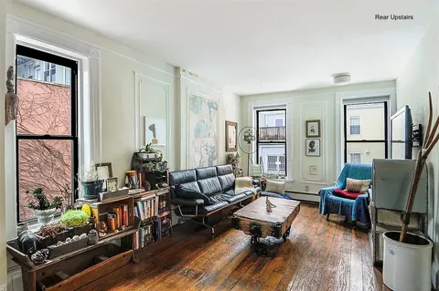 a living room with furniture fireplace and a window