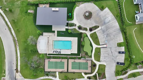 an aerial view of a house with a swimming pool and outdoor seating