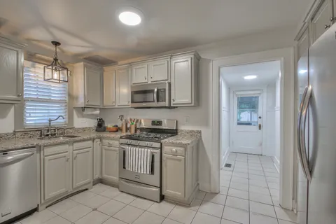 a kitchen with stainless steel appliances granite countertop a sink and cabinets