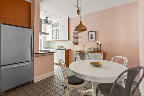 a kitchen with a dining table and chairs