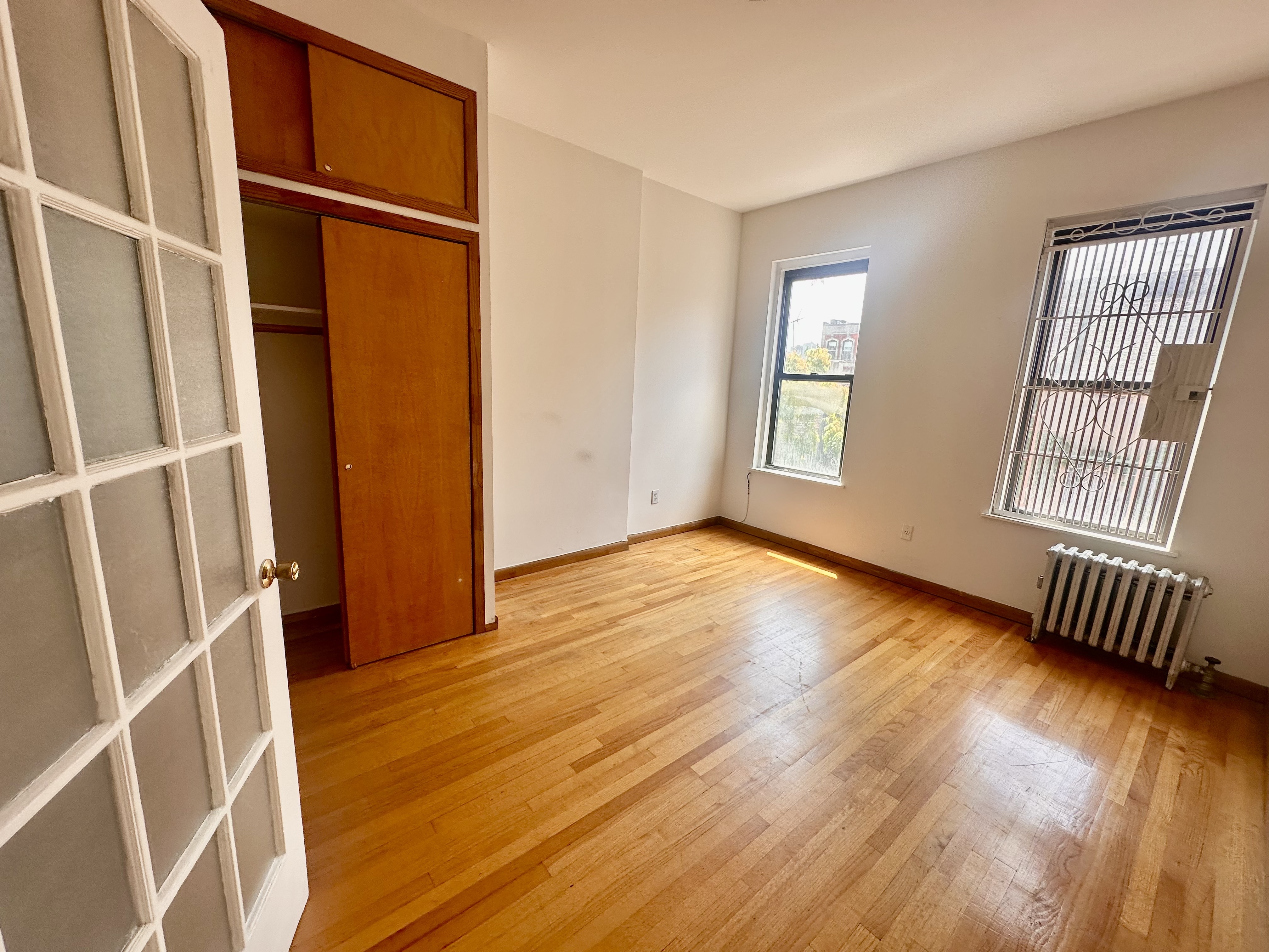 22 St Marks Place, Unit 19 Manhattan, NY 10003 - Photo 3 of 7 an empty room with wooden floor and windows