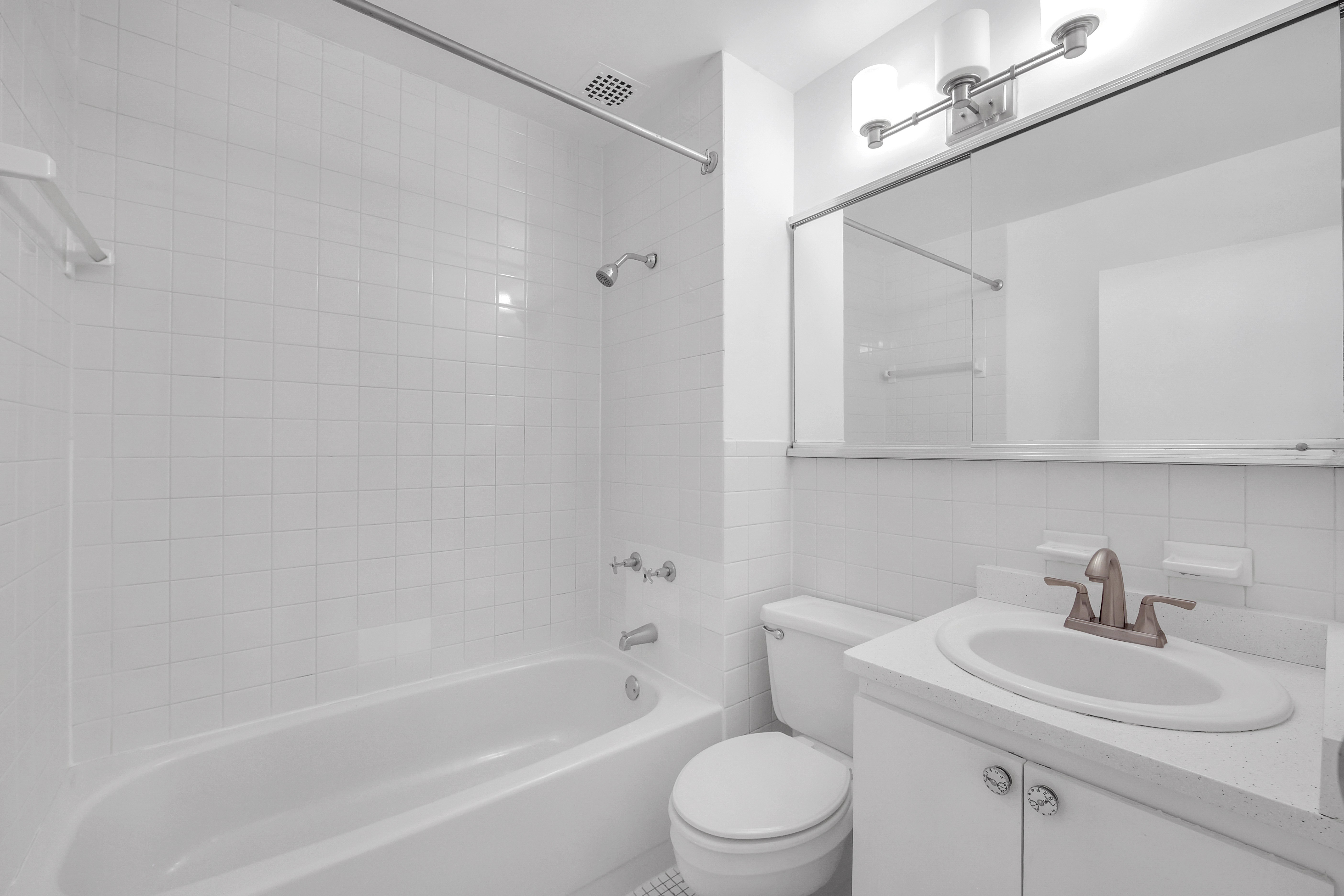 75 Livingston Street, Unit 9B Brooklyn, NY 11201 - Photo 11 of 13 a bathroom with a toilet a sink a mirror and shower