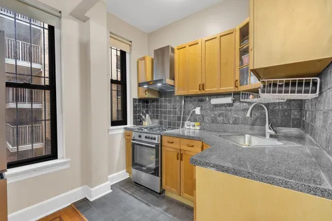 a kitchen with a sink stove and cabinets