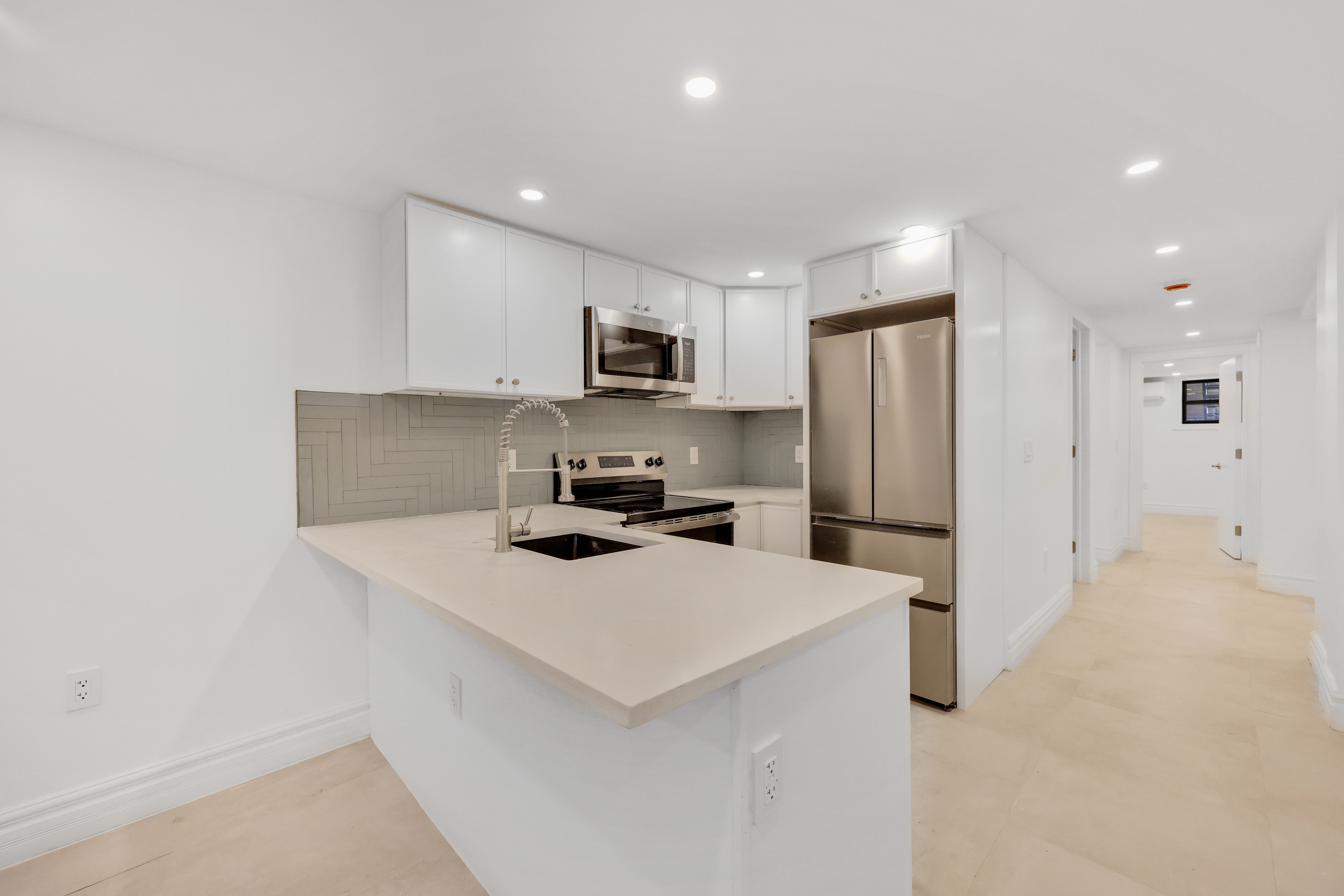 84 Pilling Street, Unit 1 Brooklyn, NY 11207 - Photo 3 of 14 a kitchen with a refrigerator a sink and a stove