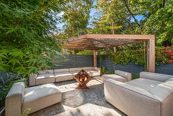 164 Sterling Street, Unit GARDEN Brooklyn, NY 11225 - Photo 5 of 5 a backyard of a house with fountain table and chairs