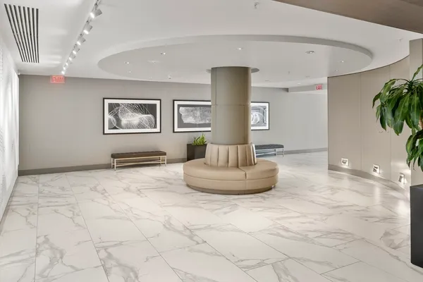 a living room with furniture a chandelier and a flat screen tv