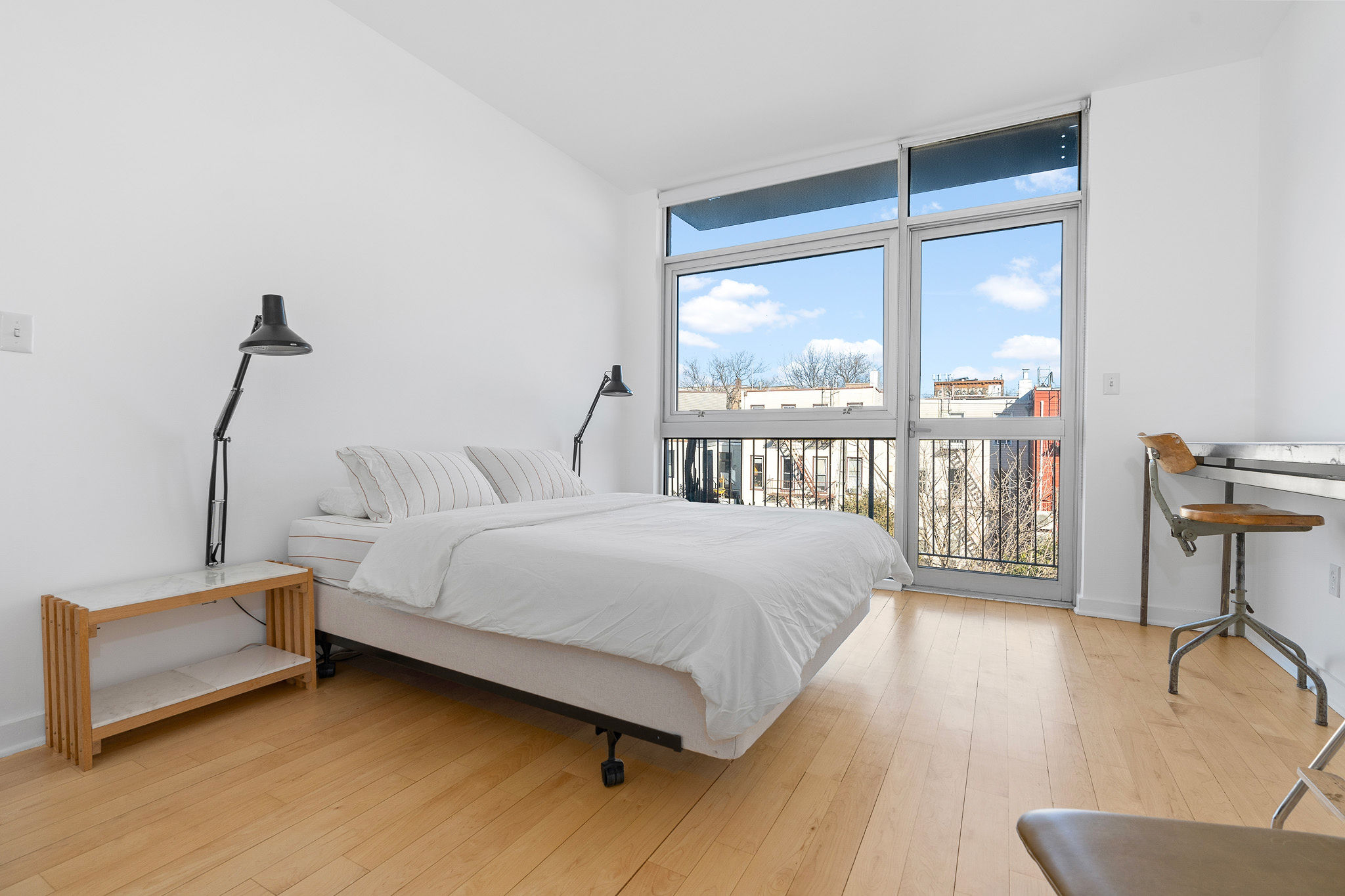 82 Guernsey Street, Unit 3B Brooklyn, NY 11222 - Photo 9 of 18 a bedroom with bed and a large window