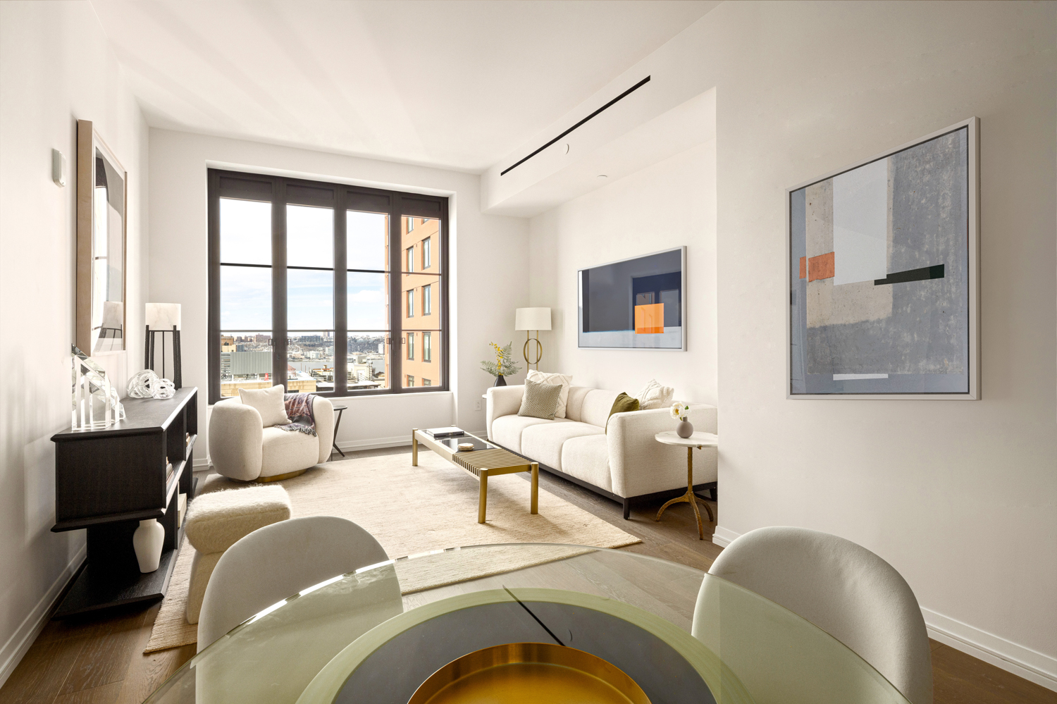 a living room with furniture and large windows