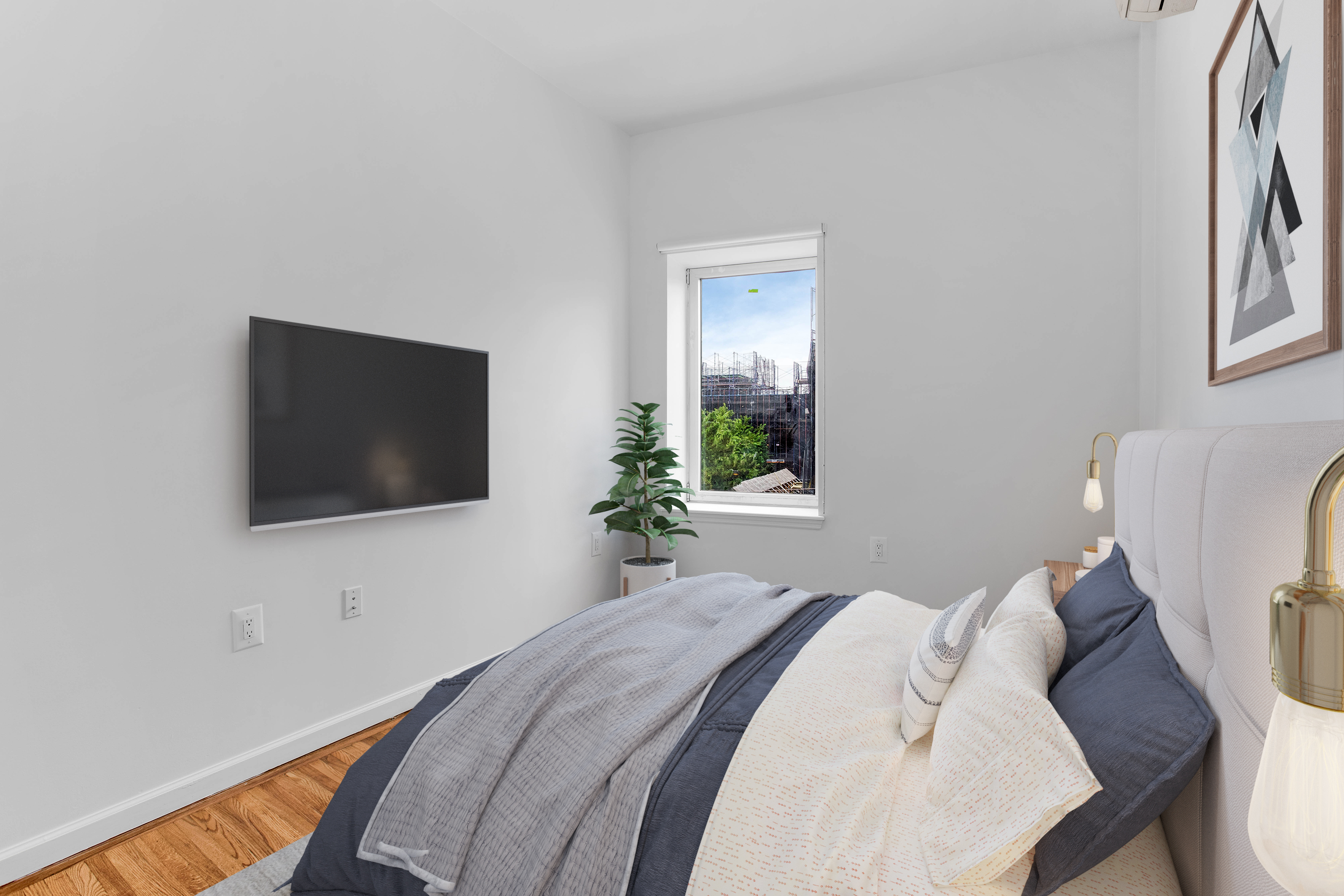 110 Bushwick Avenue, Unit 3 Brooklyn, NY 11206 - Photo 5 of 7 a bedroom with a bed and a flat screen tv