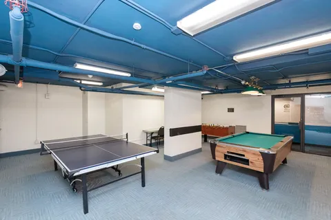 a pool with lawn chairs and a table