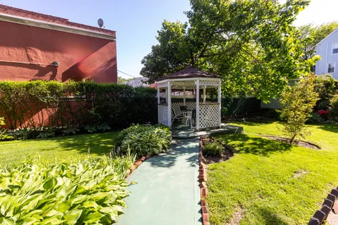 a front view of house with yard and green space