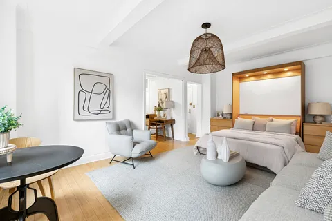 a bedroom with furniture and a window