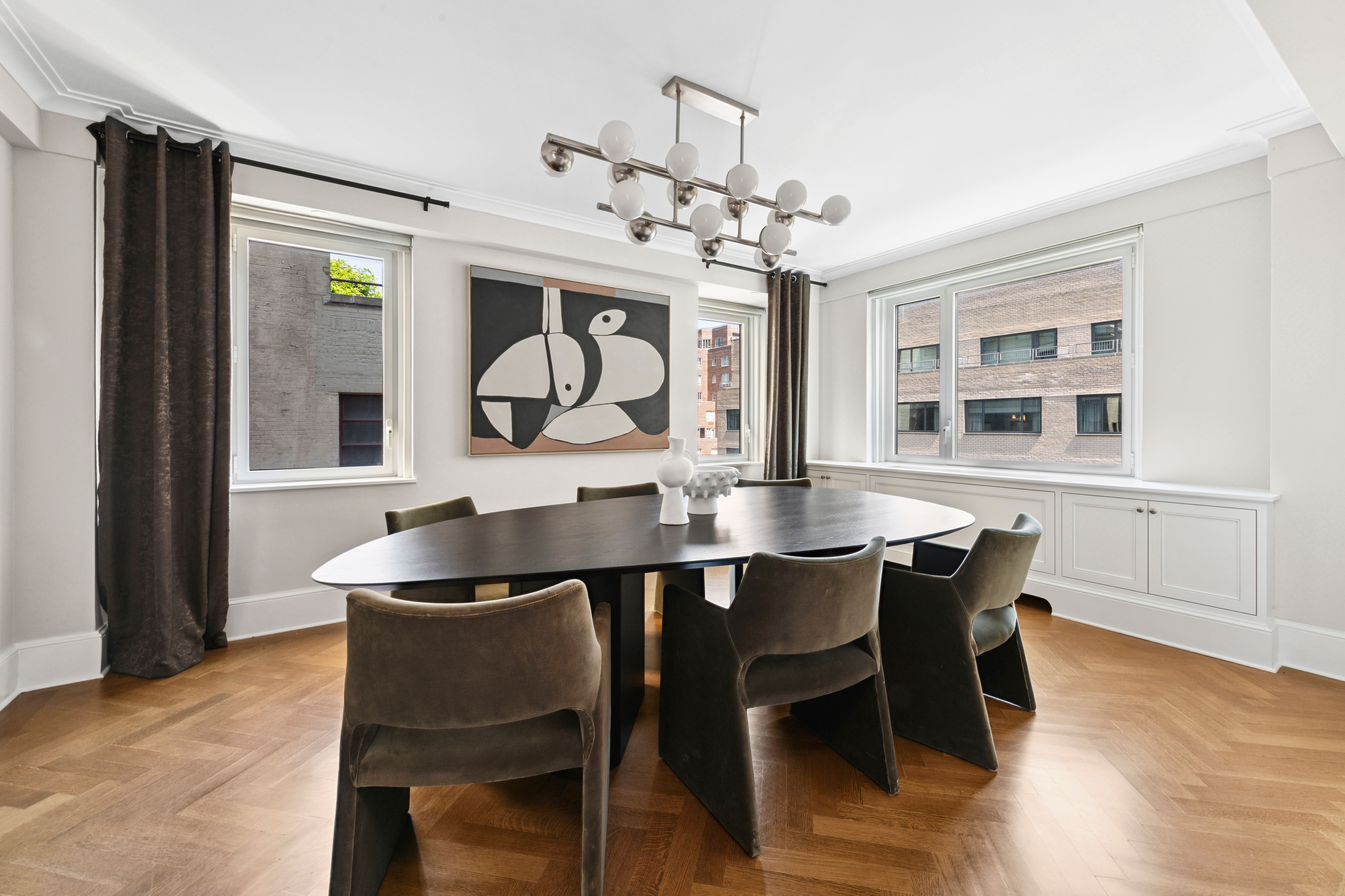 530 Park Avenue, Unit 12F Manhattan, NY 10065 - Photo 4 of 26 a view of a dining room with furniture window and wooden floor