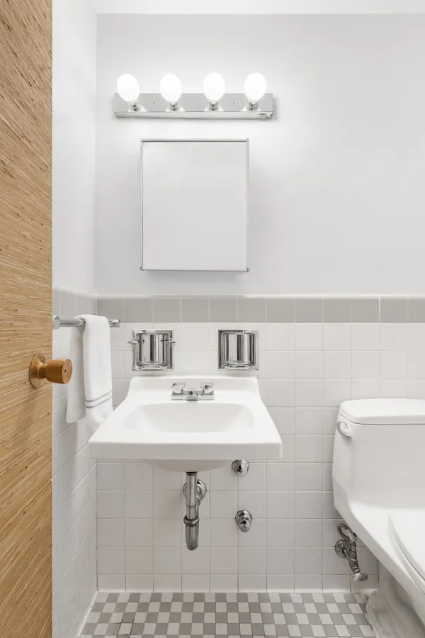 a bathroom with a sink toilet and mirror