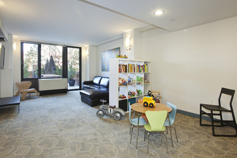 1595 Lexington Avenue, Unit 6E Manhattan, NY 10029 - Photo 10 of 13 a living room with furniture and a gym machine next to a window