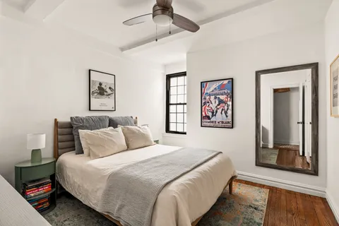 a bedroom with bed and a window