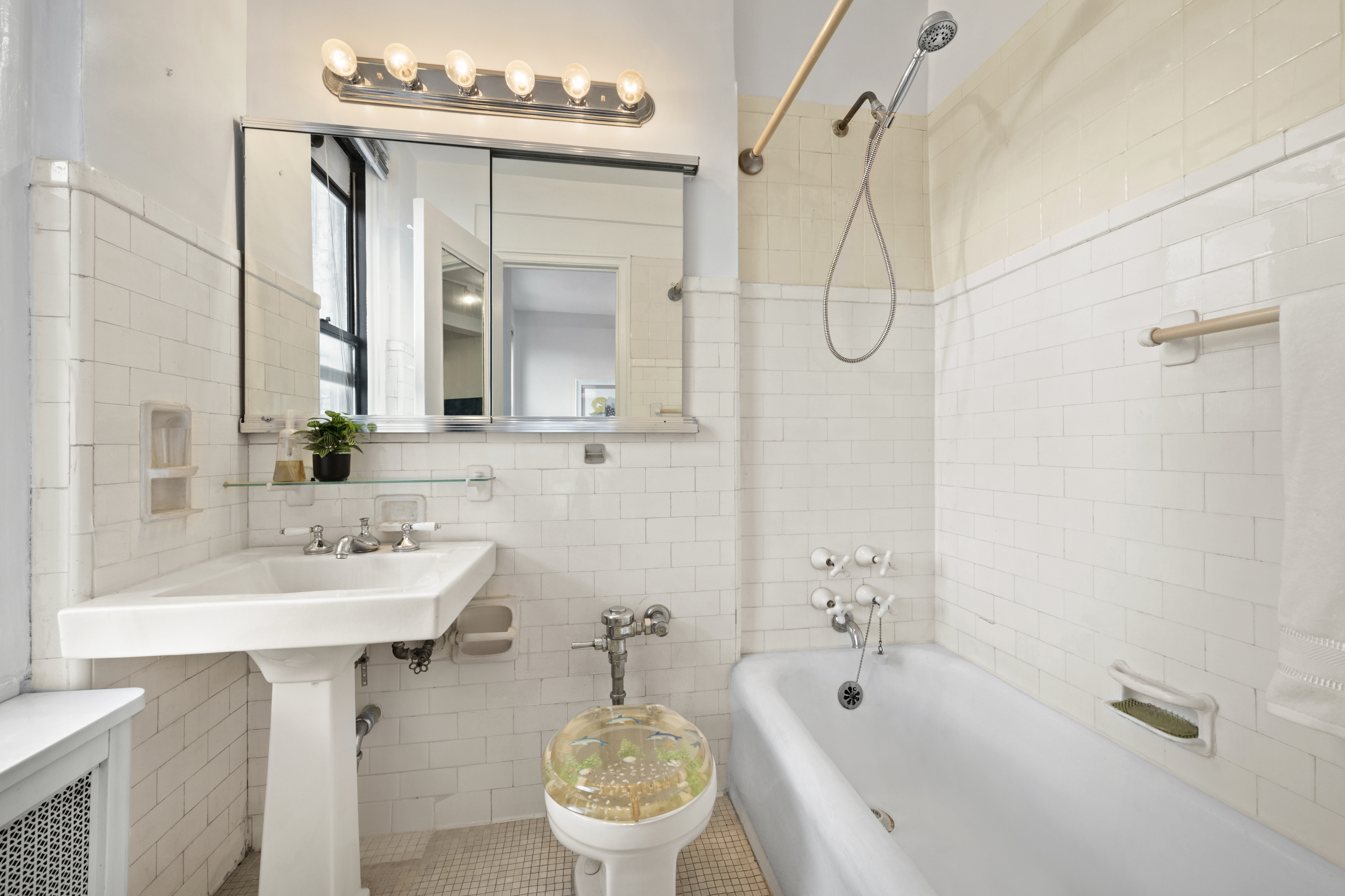 225 Central Park West, Unit 919 Manhattan, NY 10024 - Photo 6 of 15 a bathroom with a sink a toilet and shower