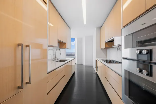 a large kitchen with a stove and a refrigerator