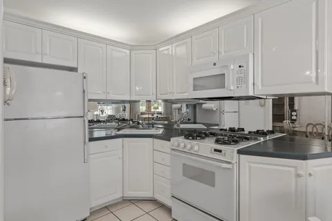 a kitchen with cabinets appliances a sink and a counter top