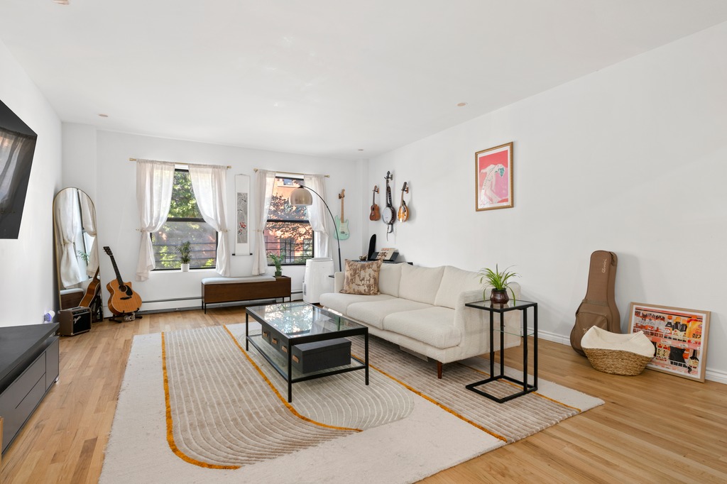 120 Manhattan Avenue, Unit 2A Manhattan, NY 10025 - Photo 1 of 10 a living room with furniture a rug and a large window