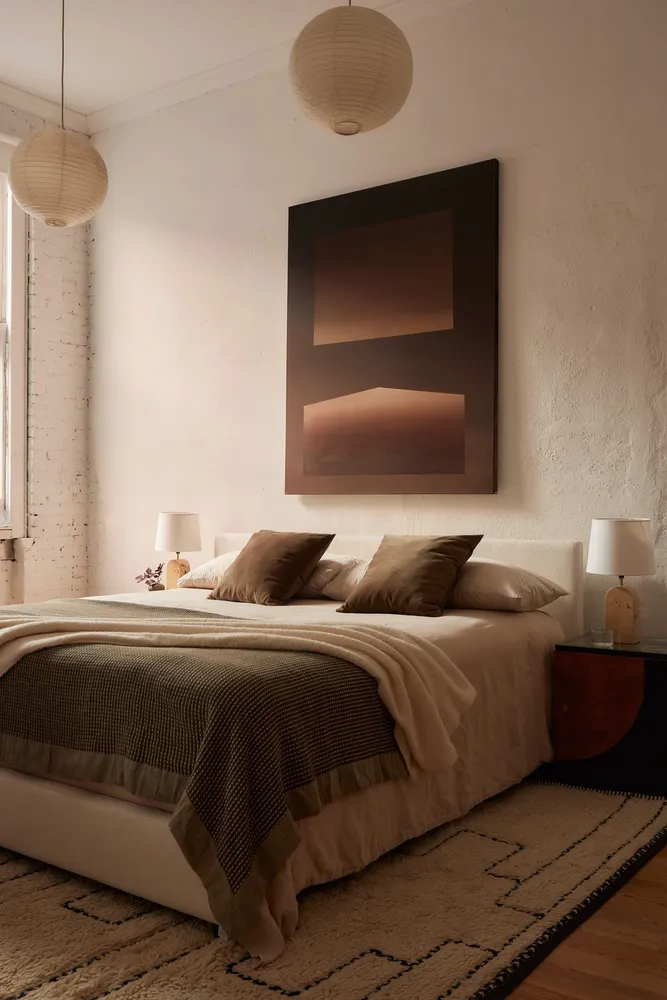 a bedroom with a bed and a lamp