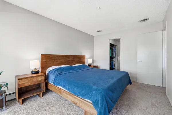 a bedroom with a bed and large window
