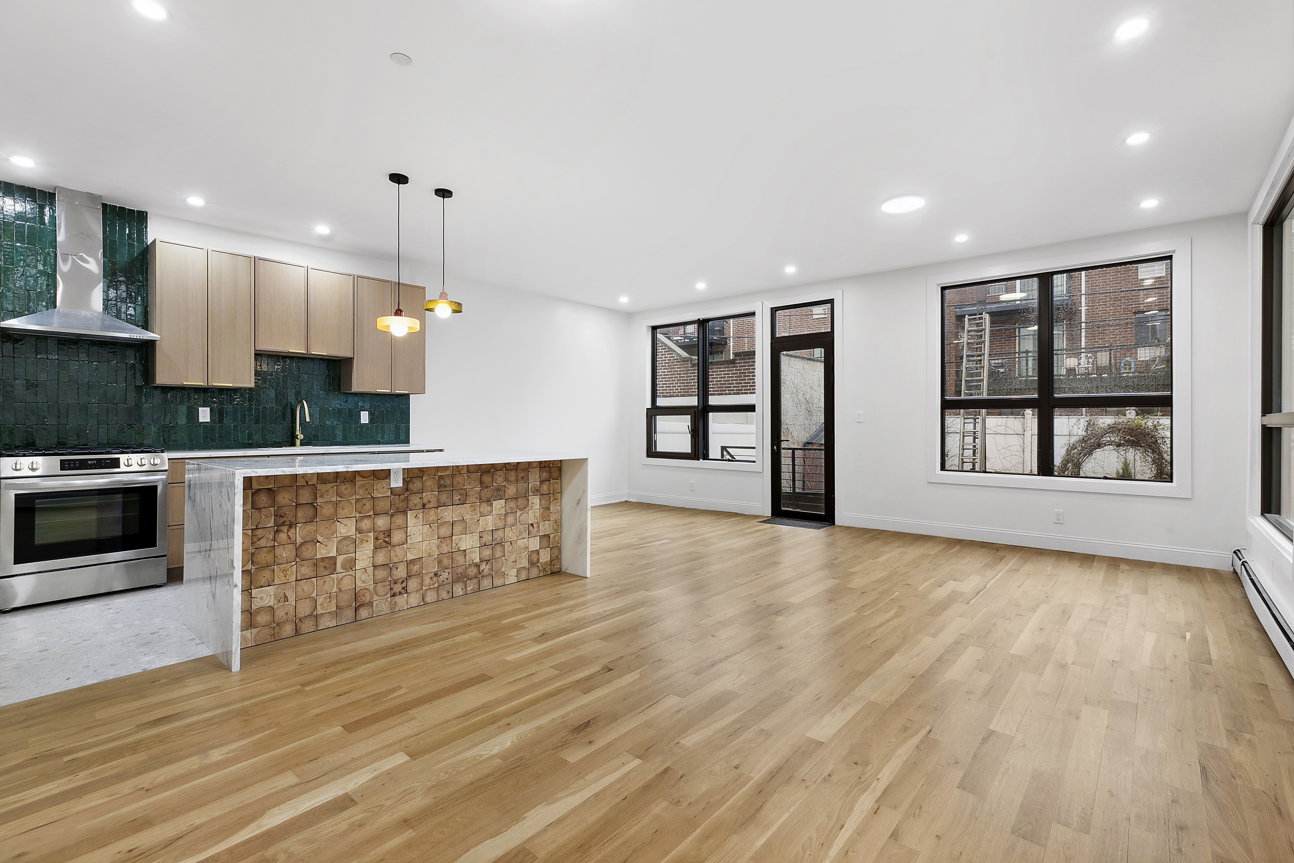 35-17 30th Street, Unit GARDEN Queens, NY 11106 - Photo 9 of 14 a view of kitchen with cabinets and wooden floor
