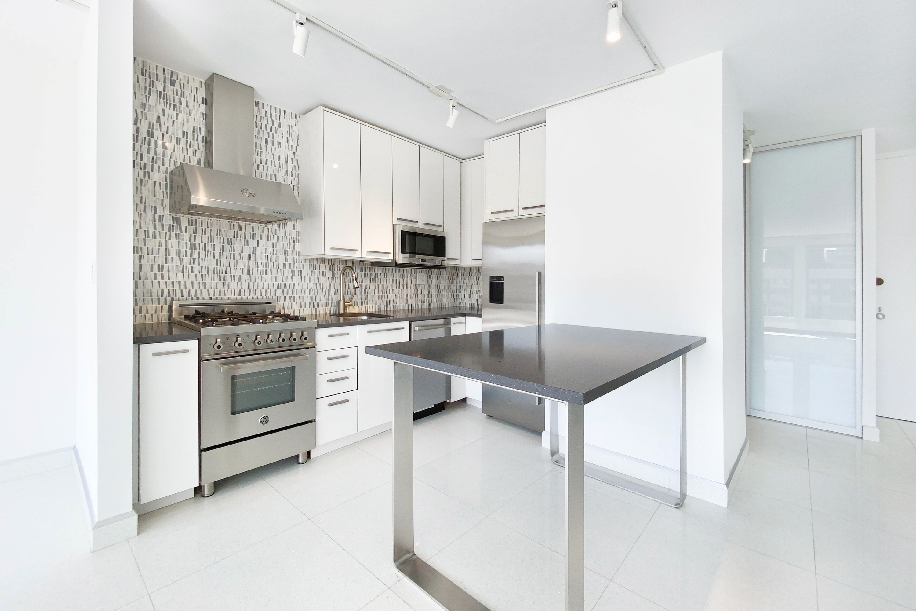 333 East 30th Street, Unit 12H Manhattan, NY 10016 - Photo 4 of 15 a kitchen with stainless steel appliances granite countertop a stove a sink and a refrigerator