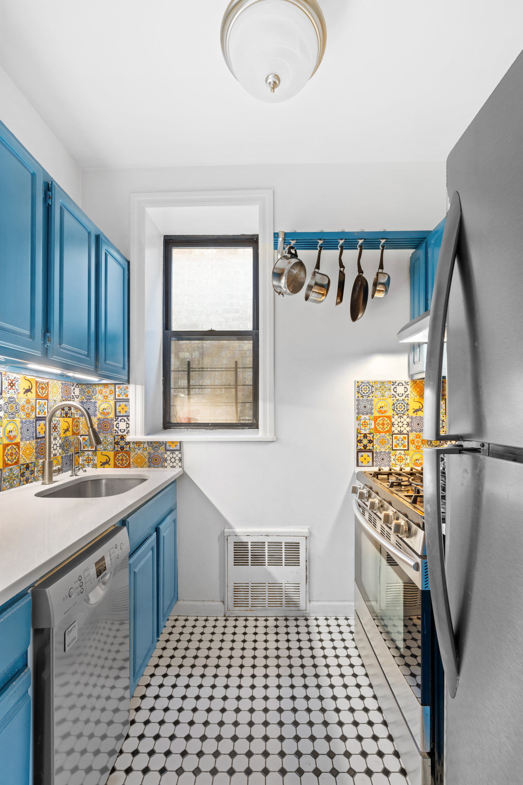 469 West 166th Street, Unit 2C Manhattan, NY 10032 - Photo 9 of 13 a kitchen with a sink a refrigerator and window