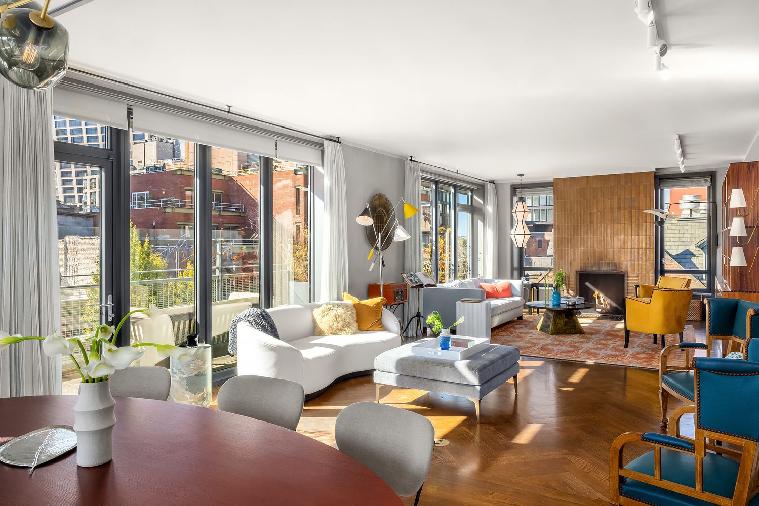 a living room with furniture and floor to ceiling windows