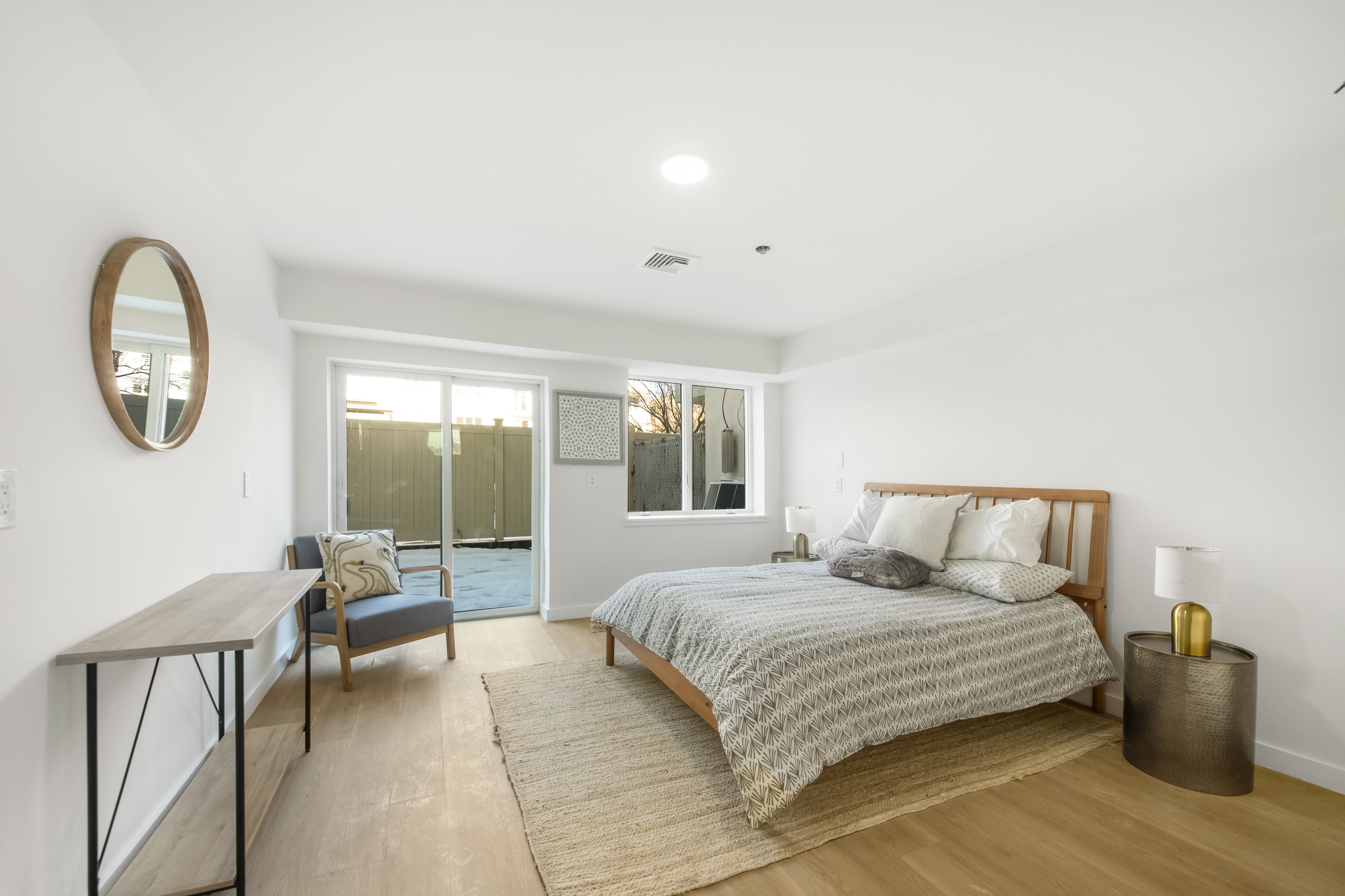 3112 Emmons Avenue, Unit 3132-1 Brooklyn, NY 11235 - Photo 4 of 12 a bedroom with a large bed and a chandelier