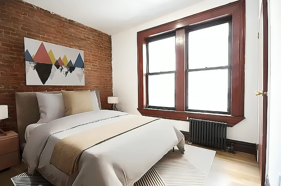 24 East 97th Street, Unit 22 Manhattan, NY 10128 - Photo 2 of 4 a bedroom with a bed and a painting on the wall