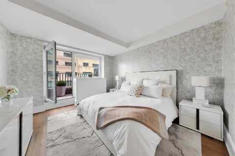 a bedroom with a large bed and a window