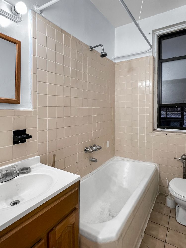 2776 Jerome Avenue, Unit 3C Bronx, NY 10468 - Photo 8 of 8 a bathroom with a sink a toilet and a mirror