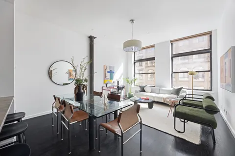 a living room with furniture a window and a chandelier