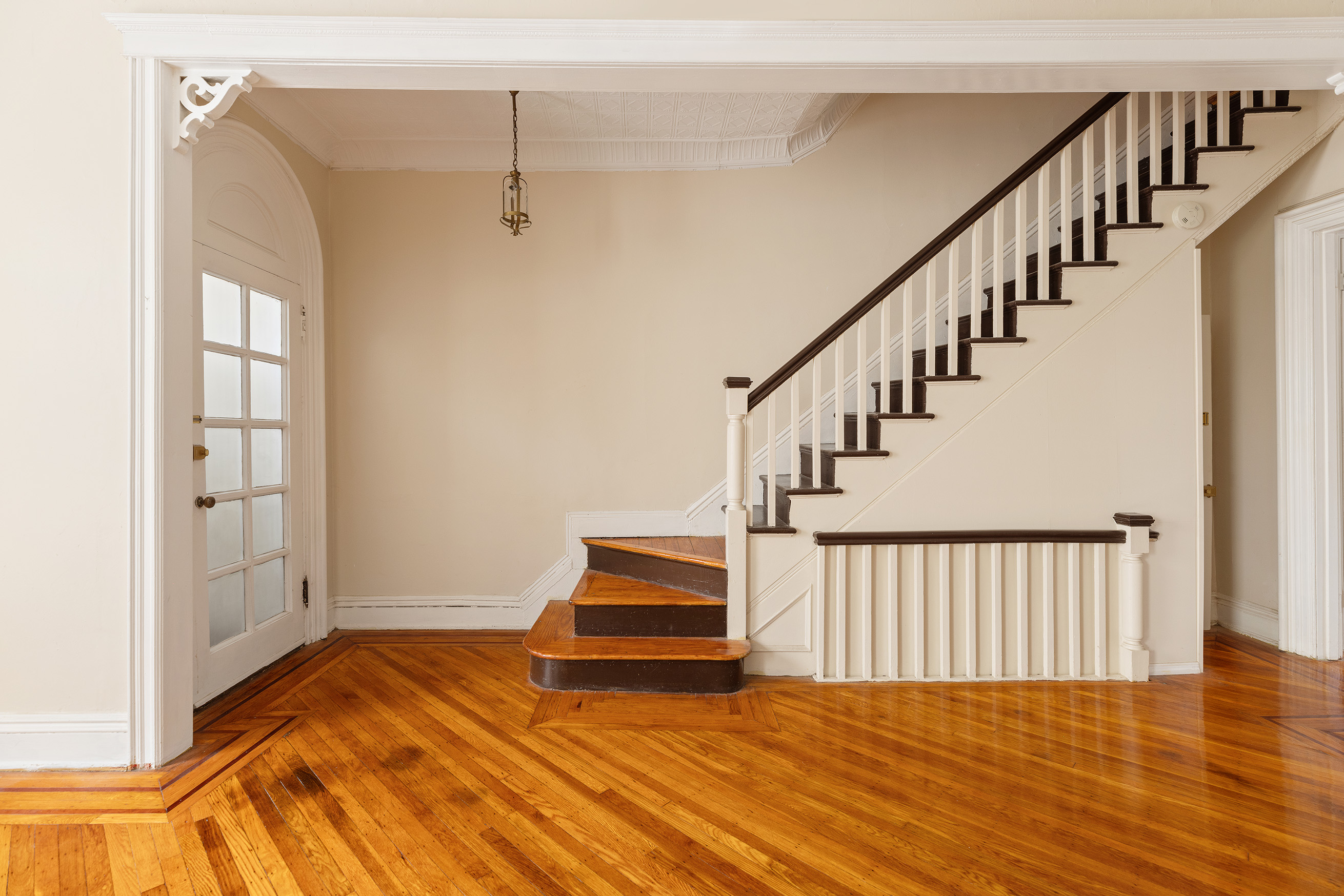 a view of staircase with white walls and wooden floor