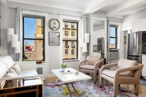 a living room with furniture a large window and a table
