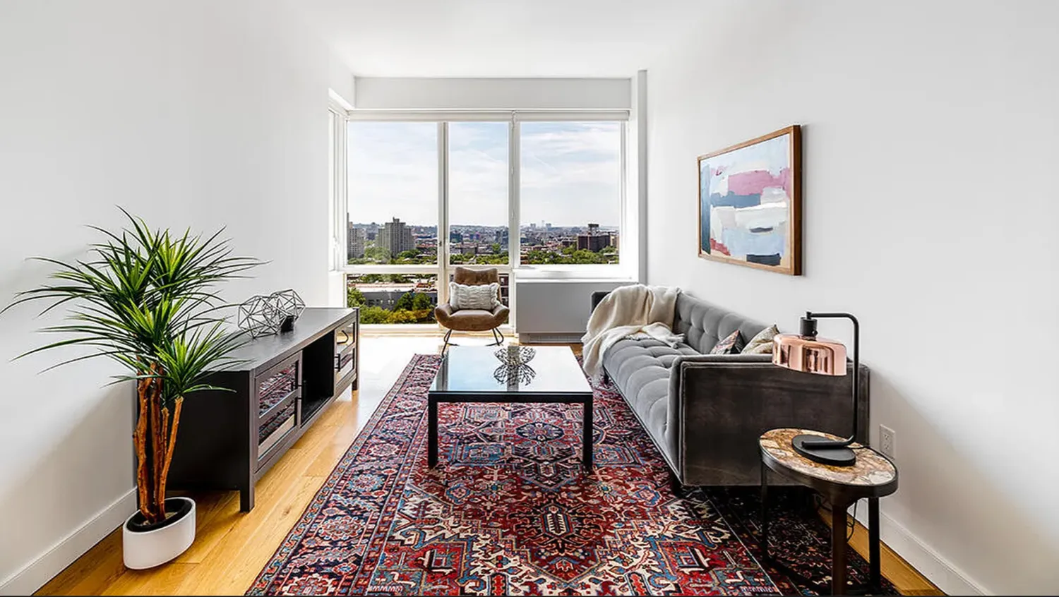 a living room with furniture and a potted plant