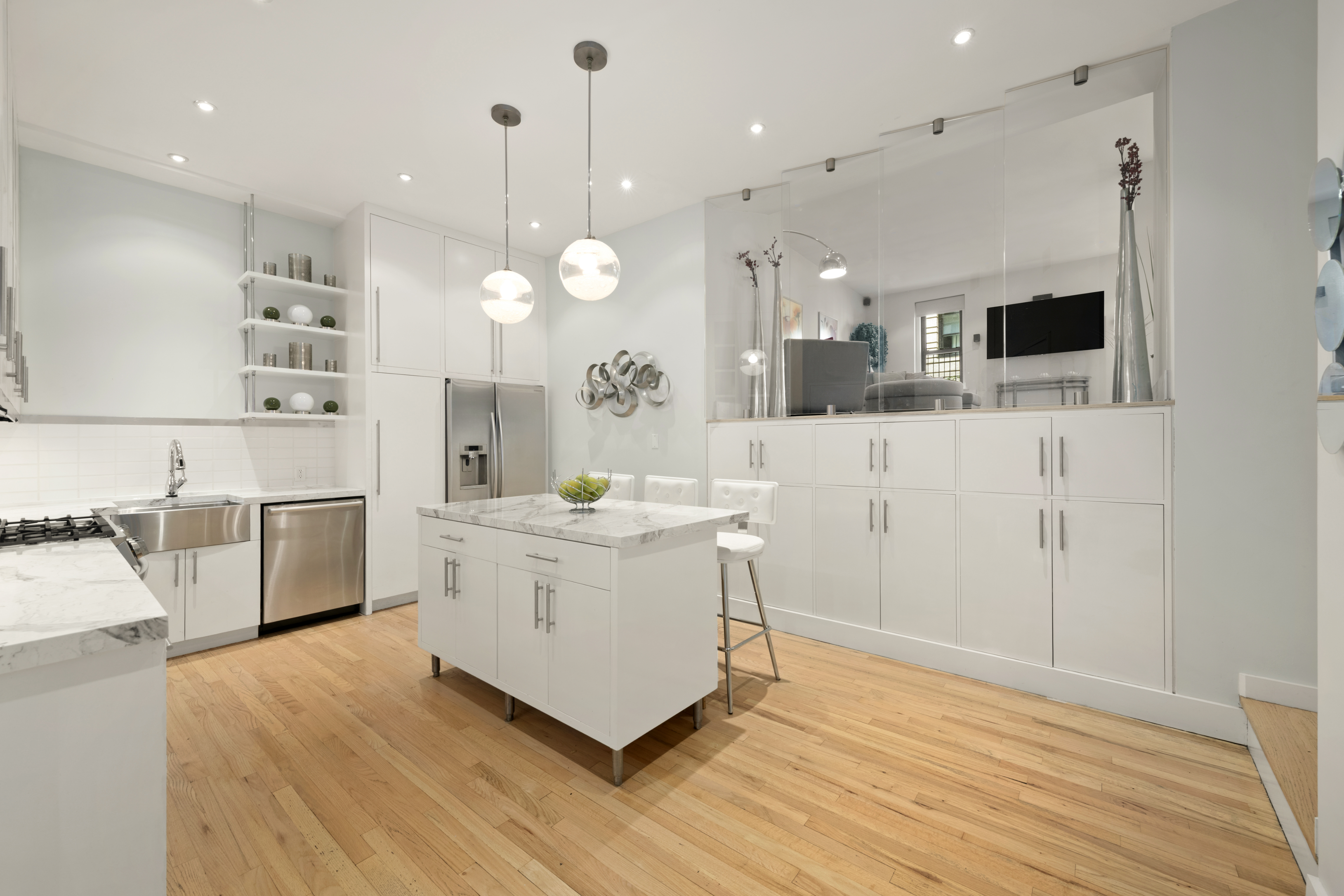 176 Broadway, Unit 9F Manhattan, NY 10038 - Photo 2 of 9 a large white kitchen with a stove a sink dishwasher and a refrigerator with wooden floor
