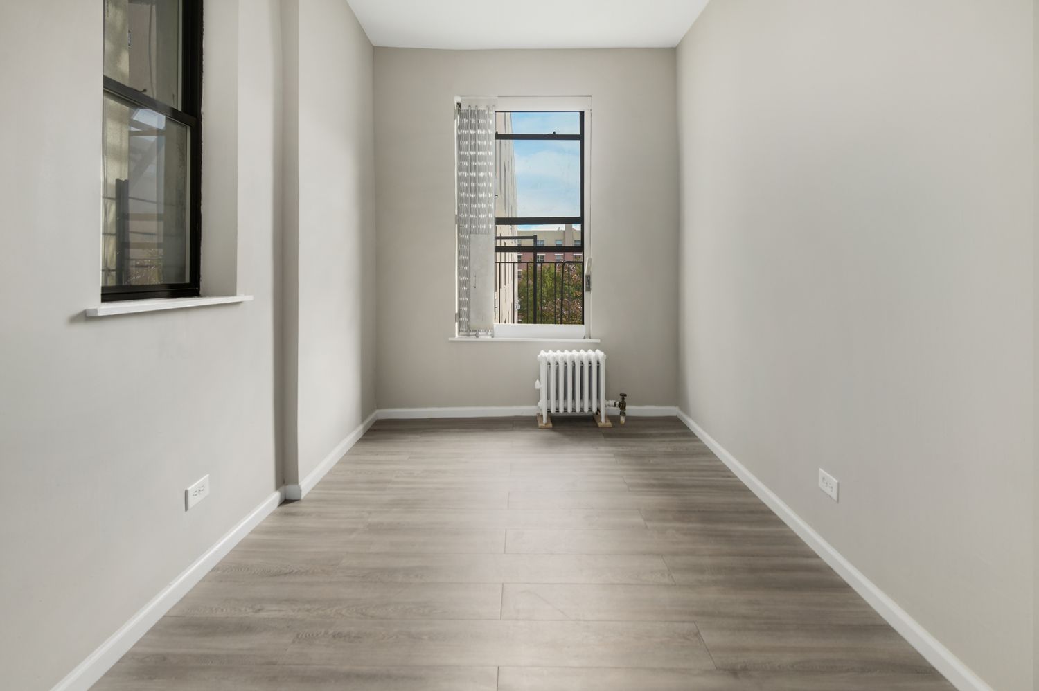 1777 Madison Avenue, Unit 32 Manhattan, NY 10035 - Photo 5 of 16 an empty room with wooden floor and windows