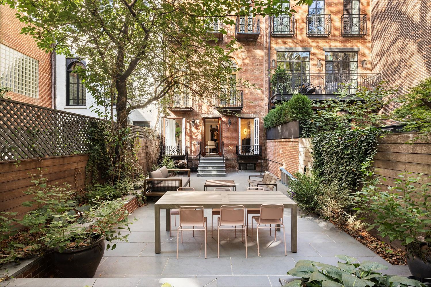 136 East 65th Street Manhattan, NY 10065 - Photo 2 of 20 a view of a patio with table and chairs and potted plants