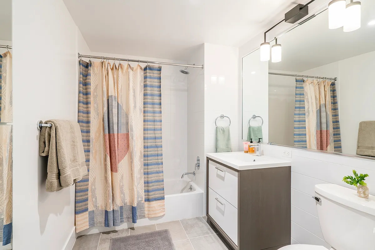 350 Clarkson Avenue, Unit 307 Brooklyn, NY 11226 - Photo 5 of 5 a bathroom with a sink a toilet and a mirror